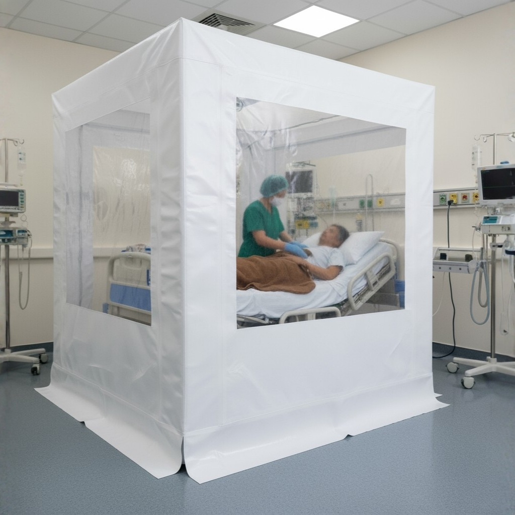 A temporary, square white hospital enclosure made of flexible material with clear plastic windows. Inside, a nurse wearing scrubs is tending to a patient lying in a hospital bed.