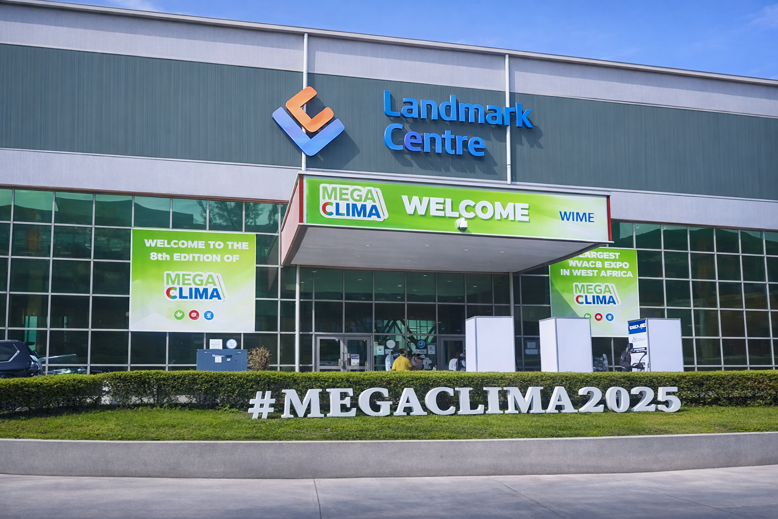 The entrance to the Landmark Centre featuring a large #MEGACLIMA2025 sign and green banners for the 8th Mega Clima HVAC expo in West Africa.